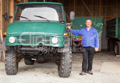 farmer standing in front of his tractor