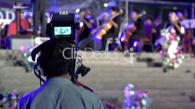 Cameraman with television shoots happening on stage