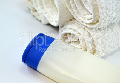 Stack of towels with pot of cream