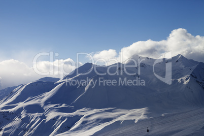 view on ski slope and sunlight mountains in evening