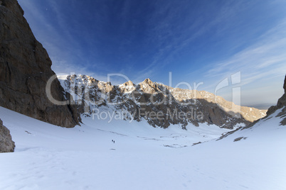 two hikers on snowy mountains in morning