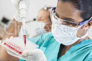 asian female laboratory scientist pipette & blood sample