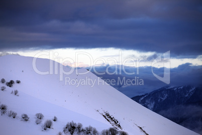 off-piste slope and cloudy sky at sunset