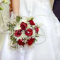 bouquet of red roses in her hand the bride