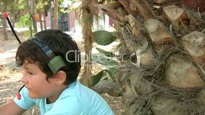 Little boy talking on his walkie talkie.