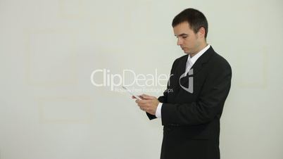 Businessman texting on digital tablet