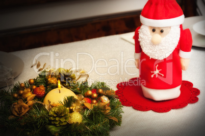 Christmas centerpiece with candle and bottle as Santa Claus