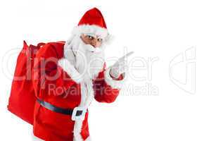 Young Santa Claus pointing on white background