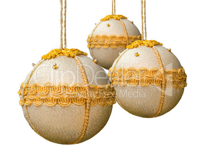 Homemade christmas balls coated with golden fabric.