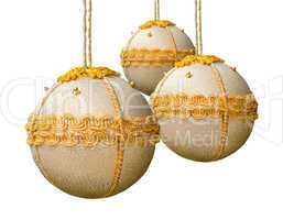 Homemade christmas balls coated with golden fabric.