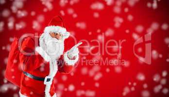 Santa Claus pointing in blank red with snow