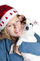Woman with christmas hat hugging her jack russell