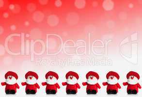 Row of puppets of Santa Claus on a red background with snow