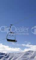 chair lift and snowy mountains at nice day