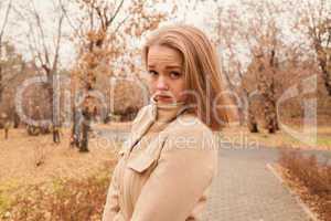 portrait of a beautiful girl in the park in autumn