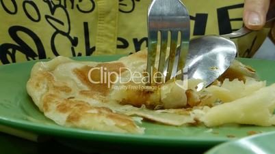 Eating egg-fried roti prata. Indian fried pancake (EATING ROTI PARATA--1)