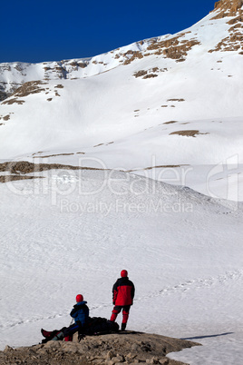 two hikers on halt in snow mountains