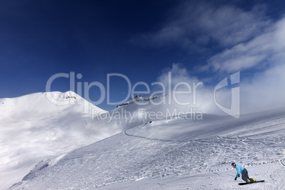 snowboarder on ski slope at nice day