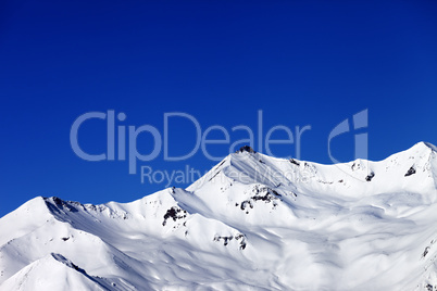 off-piste slope and blue clear sky in nice winter day