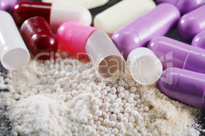 macro shot of medical powder from open capsules or pills