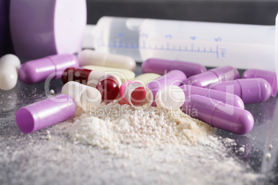 drug syringe and pills with cocaine and heroin spoiled