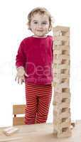 child with tower made of .toy blocks