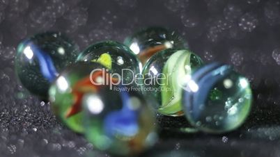 Glittering marble balls rolling