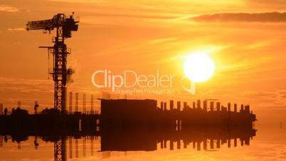 Time Lapse Sunset with Silhouettes of Crane and Workers