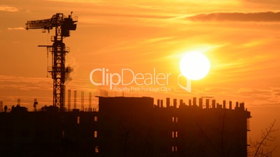 Time Lapse Sunset with Silhouettes of Crane and Workers