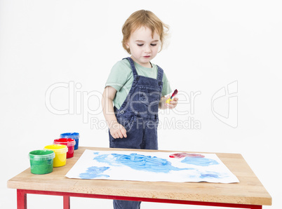 child looking at painting