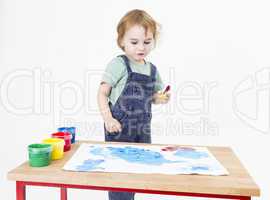 child looking at painting