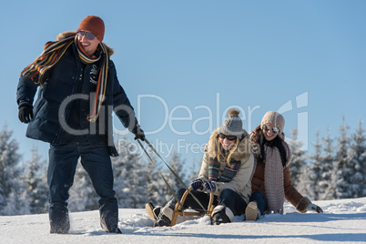 young people enjoy sunny winter day sledge