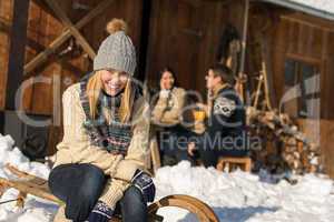 young woman with friends snow winter cottage