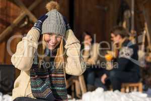 young woman in winter hat snow cottage