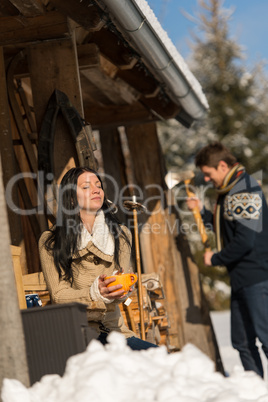 young couple on mountain winter cottage snow