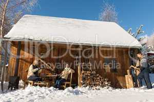 cozy wooden cottage winter snow people outside