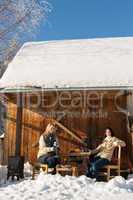 two girlfriends enjoy tea snow winter cottage