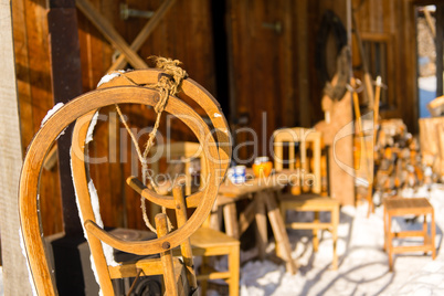 wooden sledge outside winter snow cottage