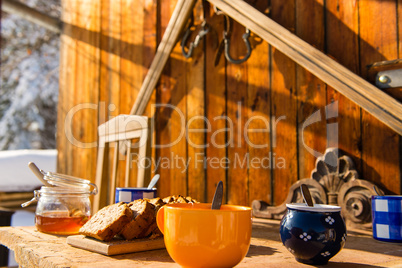 breakfast wooden table outside winter snow cottage
