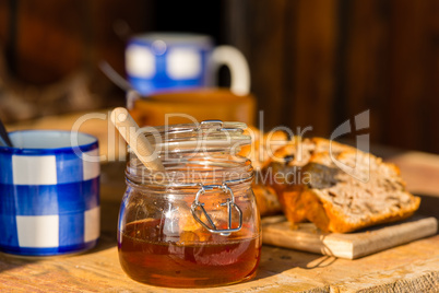 tea, honey and fruit bread on wooden table