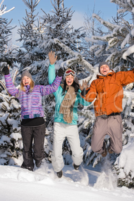 group of teenagers jumping together in wintertime
