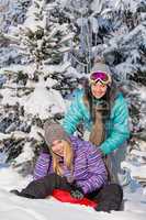 two teenage friends enjoy winter snow bobsleigh