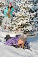 two female friends enjoy snow winter countryside