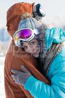 young couple embracing winter countryside ski snow