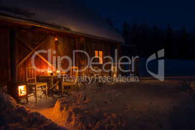 cozy wooden cottage in dark winter forest