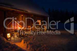 cozy wooden cottage in dark winter forest