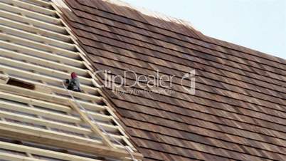 Half finished pine tared cedar wooden shingle roof