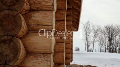 Close image of the log house tenon trees covered in snow