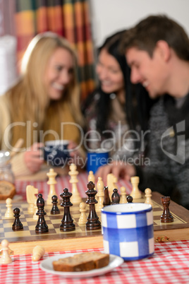 young people play chess winter cottage countryside