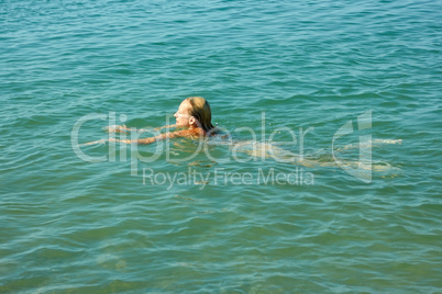 teenage girl swimming in sea water